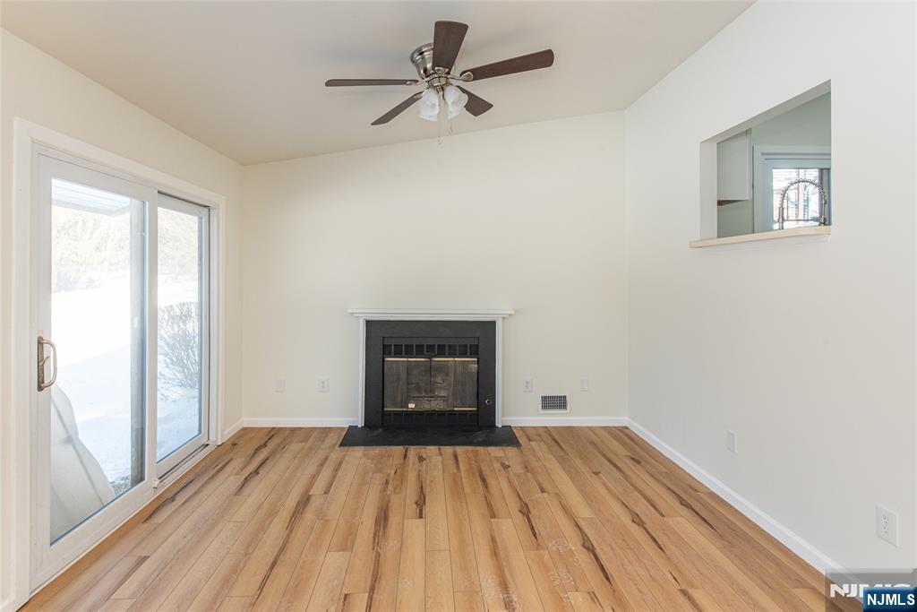 7 Summit Court Annandale, NJ 08801 - Photo 6 of 21 a view of empty room with wooden floor and fan