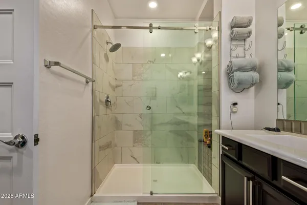 a bathroom with a shower sink and mirror