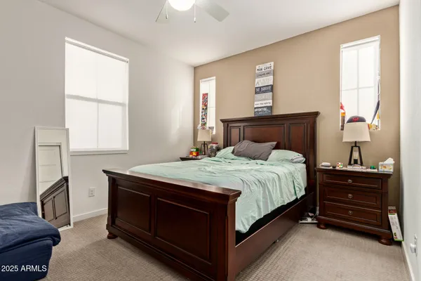 a bedroom with a bed and a window with the dresser
