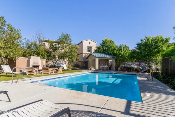 a view of a swimming pool with an outdoor seating and a garden