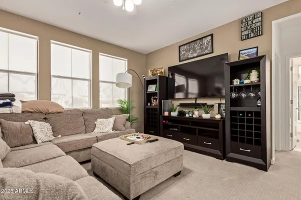 a living room with furniture a large window and a flat screen television