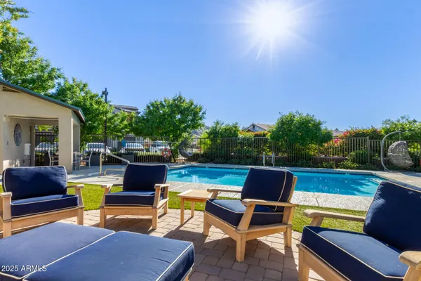 a swimming pool with outdoor seating and yard