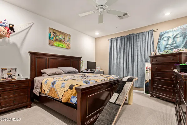 a bedroom with a bed and a chandelier