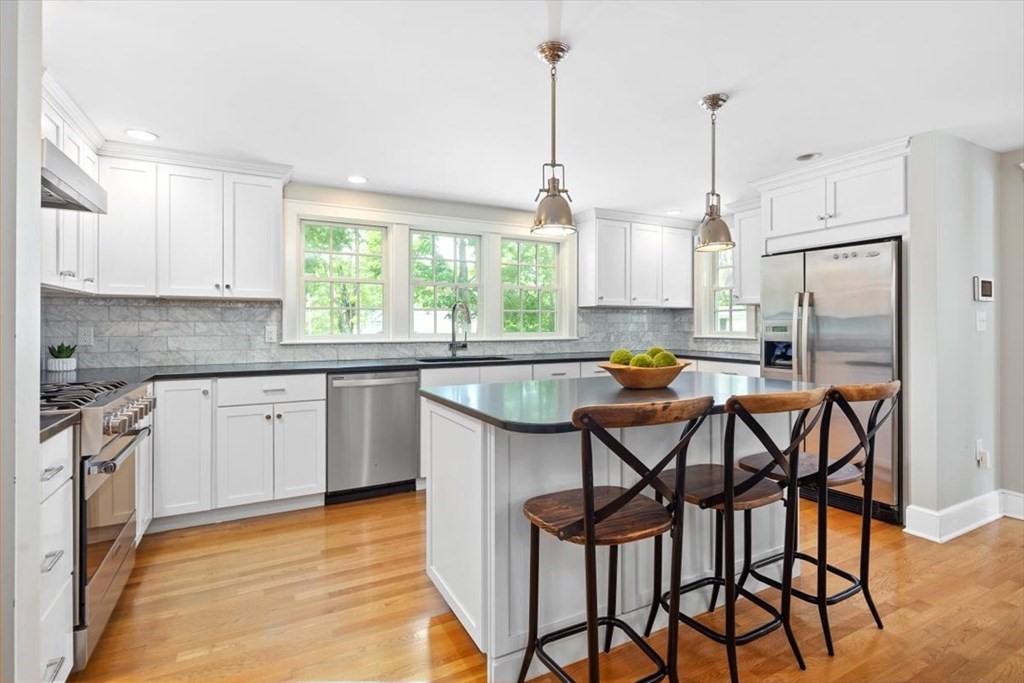 8 Merrymount Road Hingham, MA 02043 - Photo 15 of 34 a kitchen with a table chairs sink and cabinets