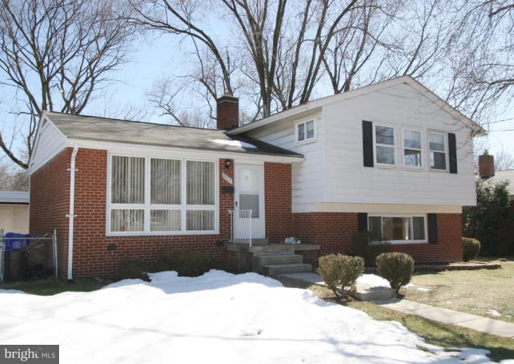 3520 Olympic Street Silver Spring, MD 20906 - Photo 1 of 24 a front view of a house with a yard covered in snow