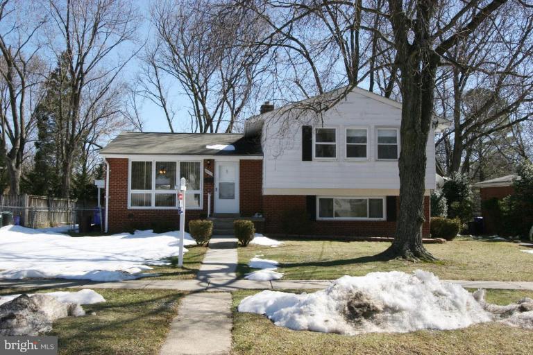 3520 Olympic Street Silver Spring, MD 20906 - Photo 15 of 24 a front view of a house with a yard covered with snow