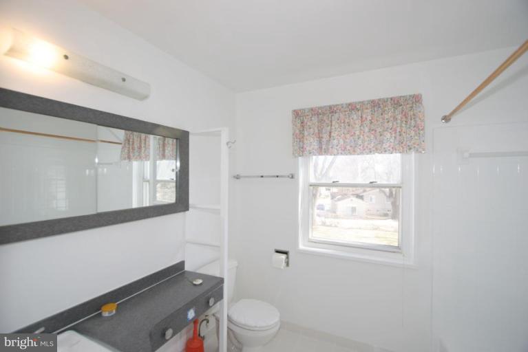 3520 Olympic Street Silver Spring, MD 20906 - Photo 16 of 24 a bathroom with a toilet a sink and a window