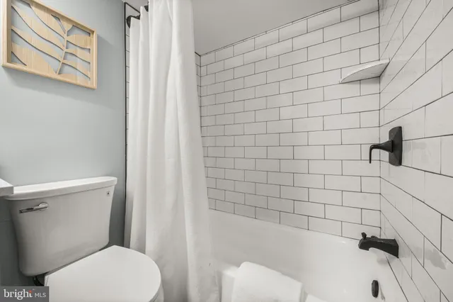 a bathroom with a toilet and shower