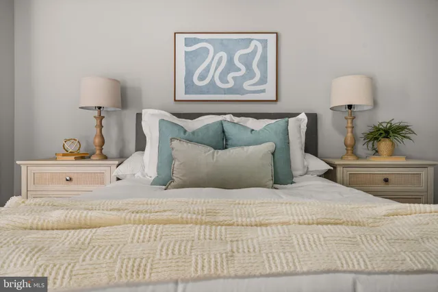 a bedroom with a bed and a lamp