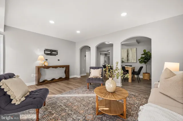 a living room with fireplace furniture and a wooden floor