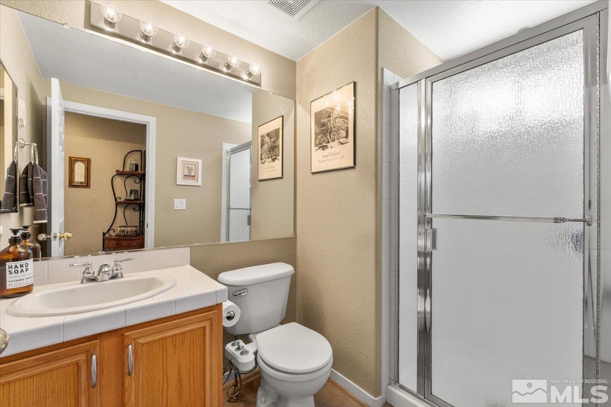 2225 Solitude Drive Reno, NV 89511 - Photo 13 of 40 a bathroom with a shower sink vanity mirror and toilet