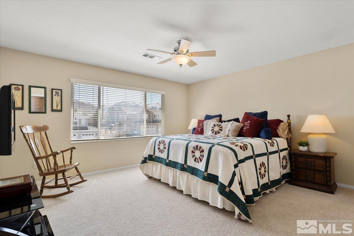 2225 Solitude Drive Reno, NV 89511 - Photo 18 of 40 a spacious bedroom with a bed chair and window