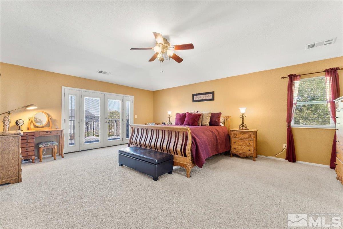 2225 Solitude Drive Reno, NV 89511 - Photo 19 of 40 a spacious bedroom with a bed and a chandelier