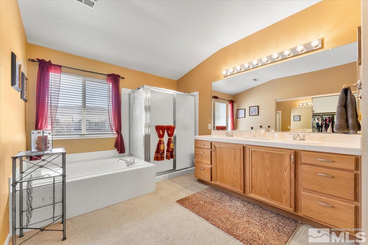 2225 Solitude Drive Reno, NV 89511 - Photo 21 of 40 a spacious bathroom with a tub sink and a mirror