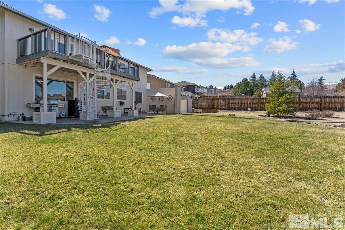 2225 Solitude Drive Reno, NV 89511 - Photo 29 of 40 a swimming pool with outdoor seating and yard