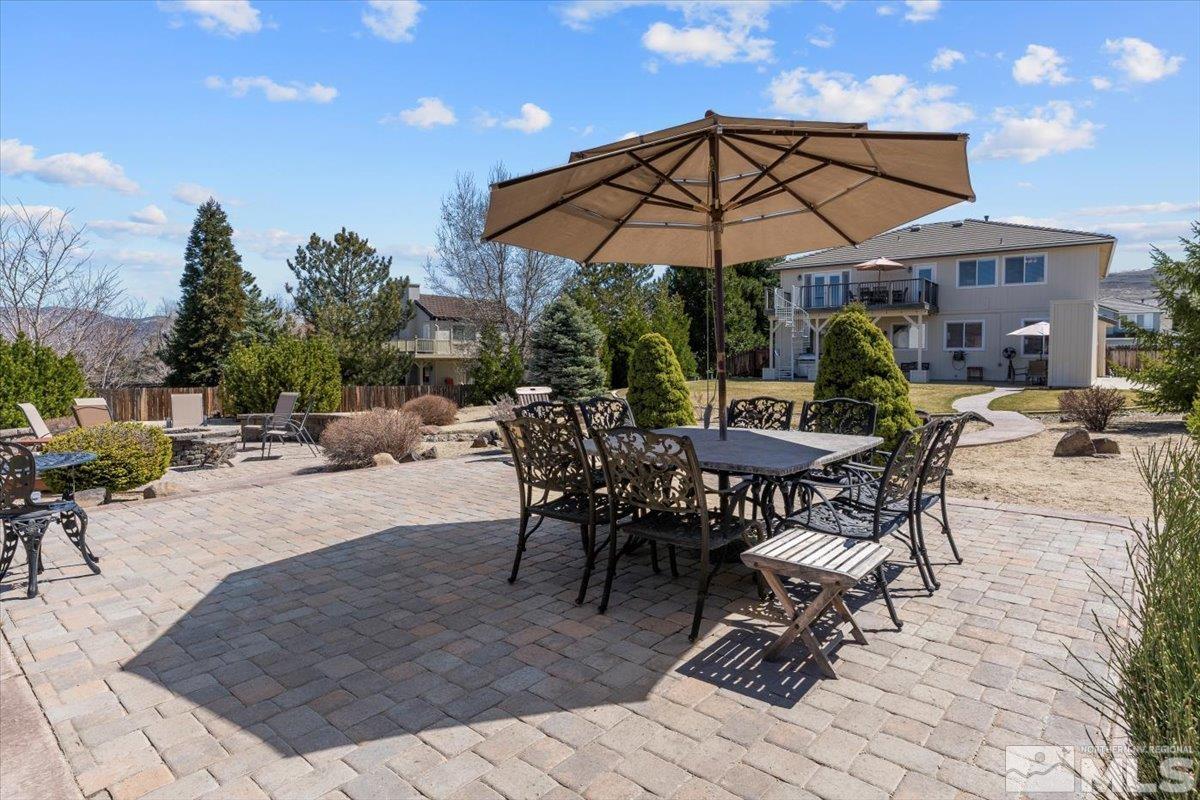 2225 Solitude Drive Reno, NV 89511 - Photo 33 of 40 a view of a patio with a table and chairs under an umbrella