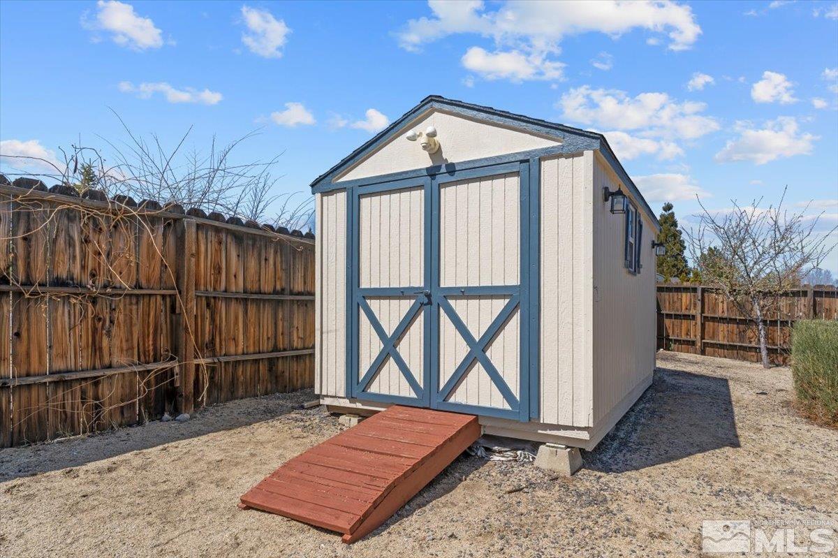 2225 Solitude Drive Reno, NV 89511 - Photo 35 of 40 a front view of a house with wooden fence
