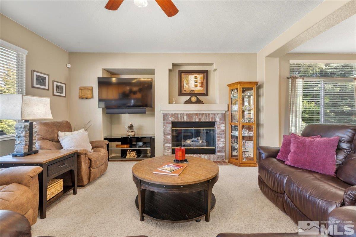2225 Solitude Drive Reno, NV 89511 - Photo 5 of 40 a living room with furniture a flat screen tv and a fireplace