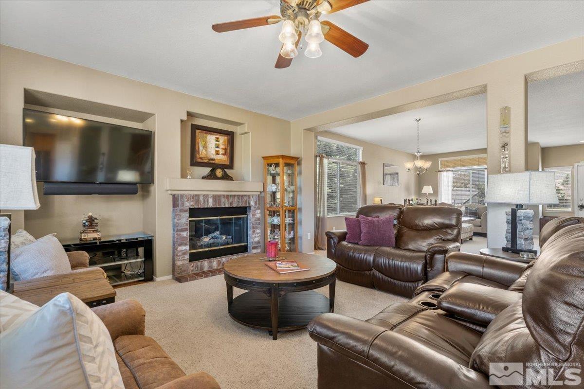 2225 Solitude Drive Reno, NV 89511 - Photo 6 of 40 a living room with furniture a fireplace and a flat screen tv