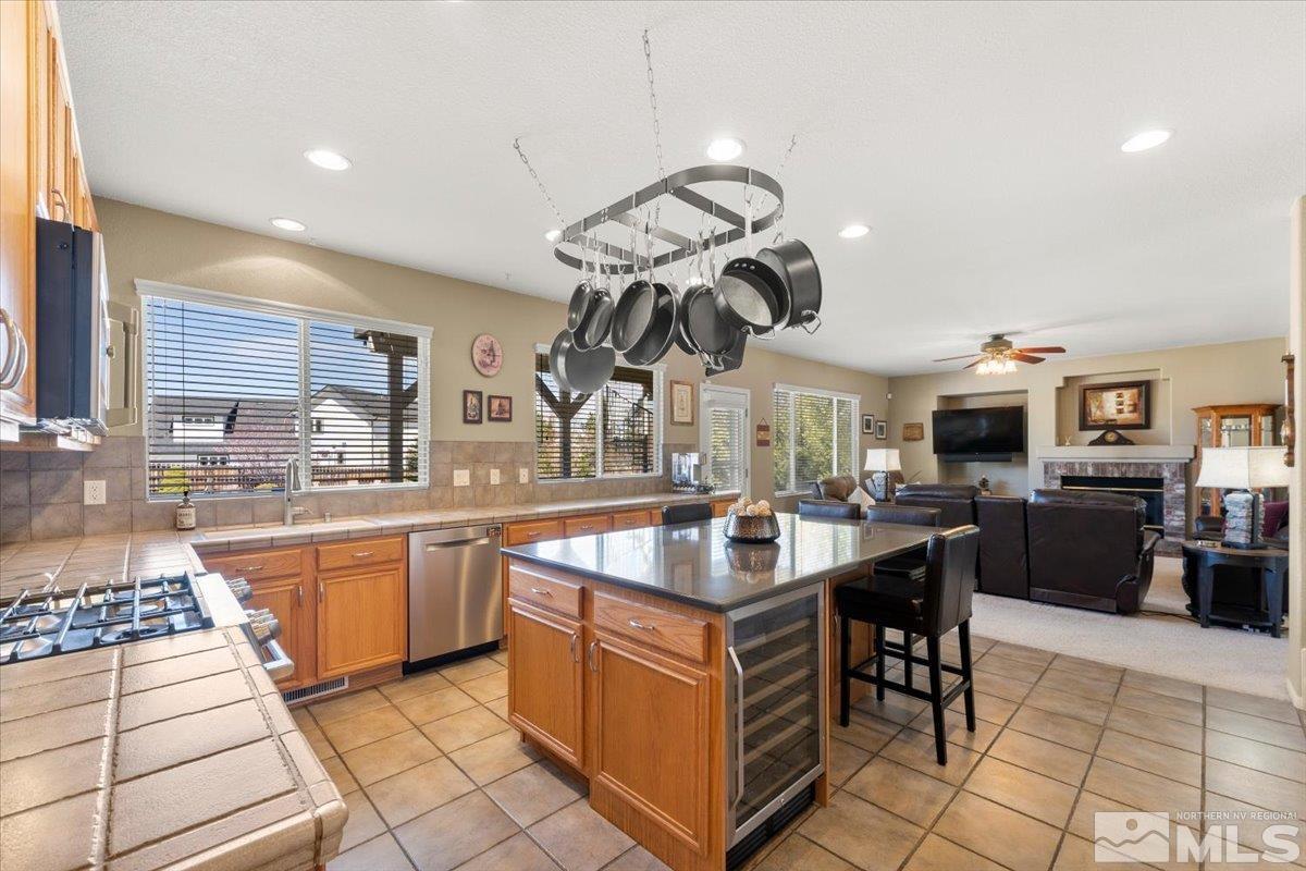 2225 Solitude Drive Reno, NV 89511 - Photo 10 of 40 a kitchen with stainless steel appliances granite countertop a sink a stove and a refrigerator