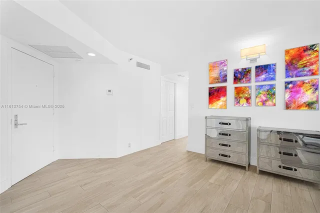 a view of a room with balcony and wooden floor
