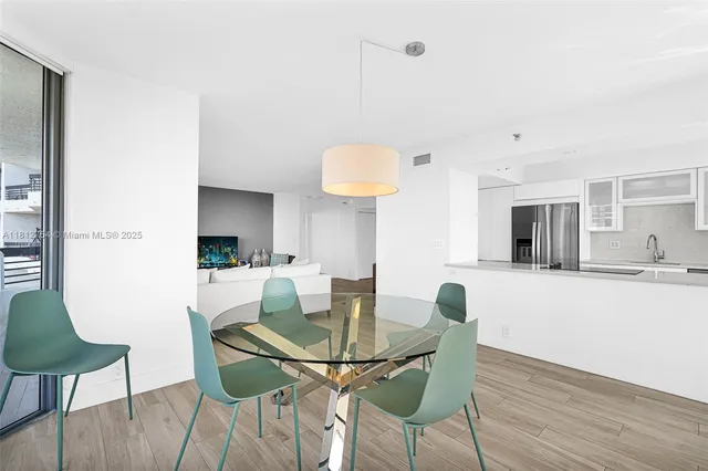 a kitchen with a large window and stainless steel appliances