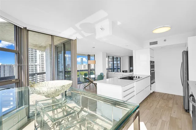 a bedroom with a large window and a potted plant