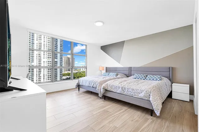 a bedroom with a bed and a large mirror