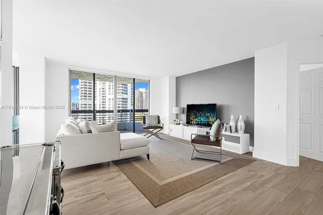 a living room with furniture and large windows