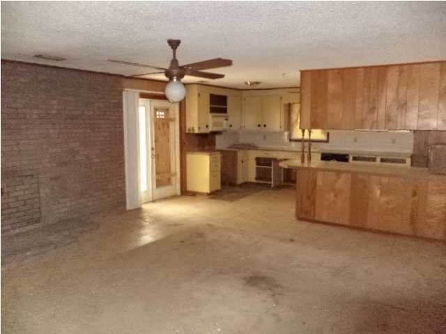 367 Cat Island Road DeFuniak Springs, FL 32433 - Photo 3 of 19 a kitchen with stainless steel appliances granite countertop a stove a sink dishwasher and a refrigerator with wooden floor