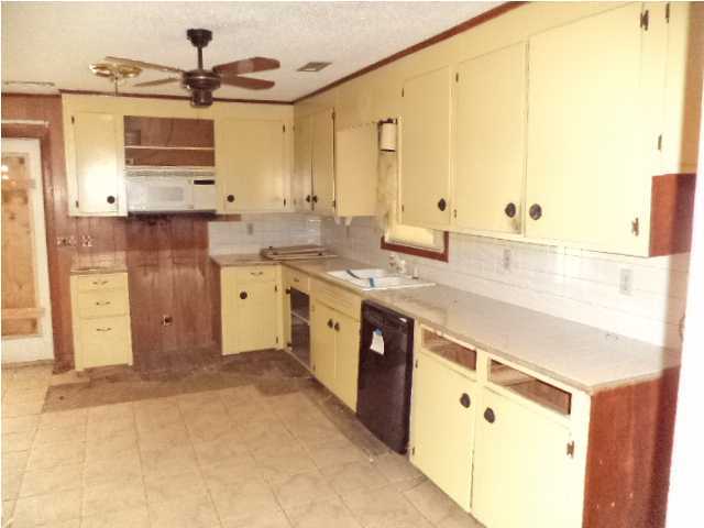 367 Cat Island Road DeFuniak Springs, FL 32433 - Photo 7 of 19 a kitchen with stainless steel appliances granite countertop a sink and a stove
