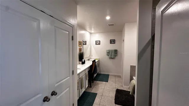 a bathroom with a double vanity sink a toilet and shower