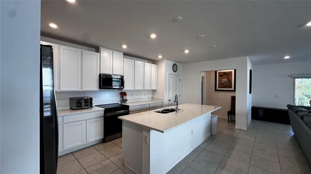 a large kitchen with a large counter top appliances and cabinets