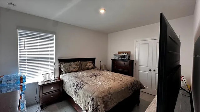 a bedroom with a bed and a closet