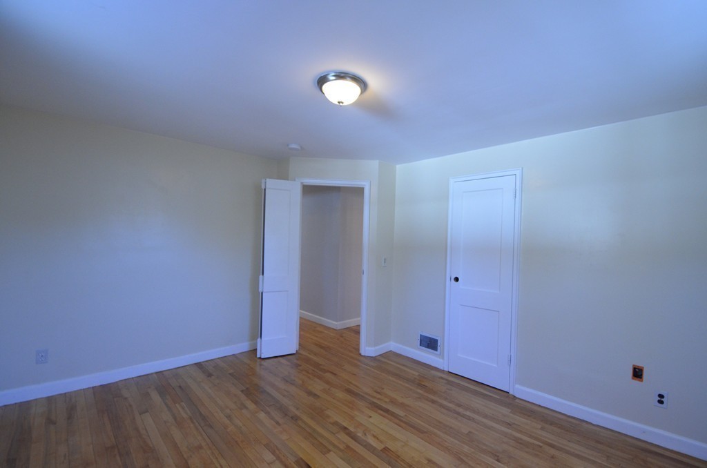 1239 Trapelo Road Waltham, MA 02451 - Photo 13 of 20 a view of an empty room with wooden floor and closet