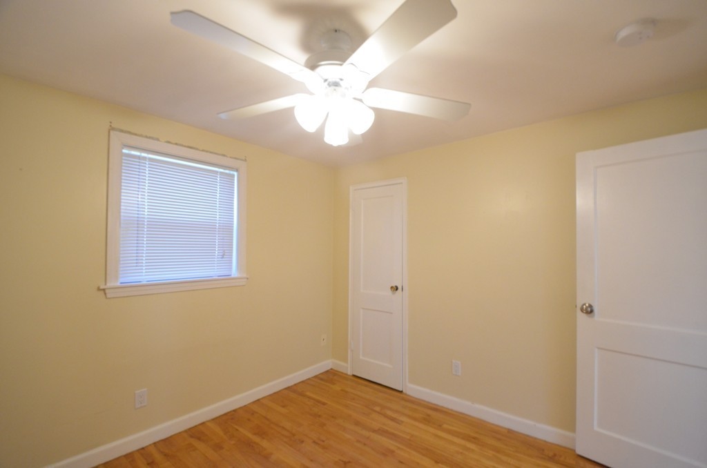 1239 Trapelo Road Waltham, MA 02451 - Photo 15 of 20 a view of an empty room with wooden floor and a fan