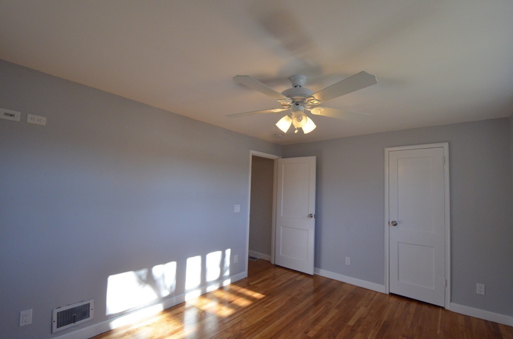 1239 Trapelo Road Waltham, MA 02451 - Photo 16 of 20 a view of an empty room with wooden floor