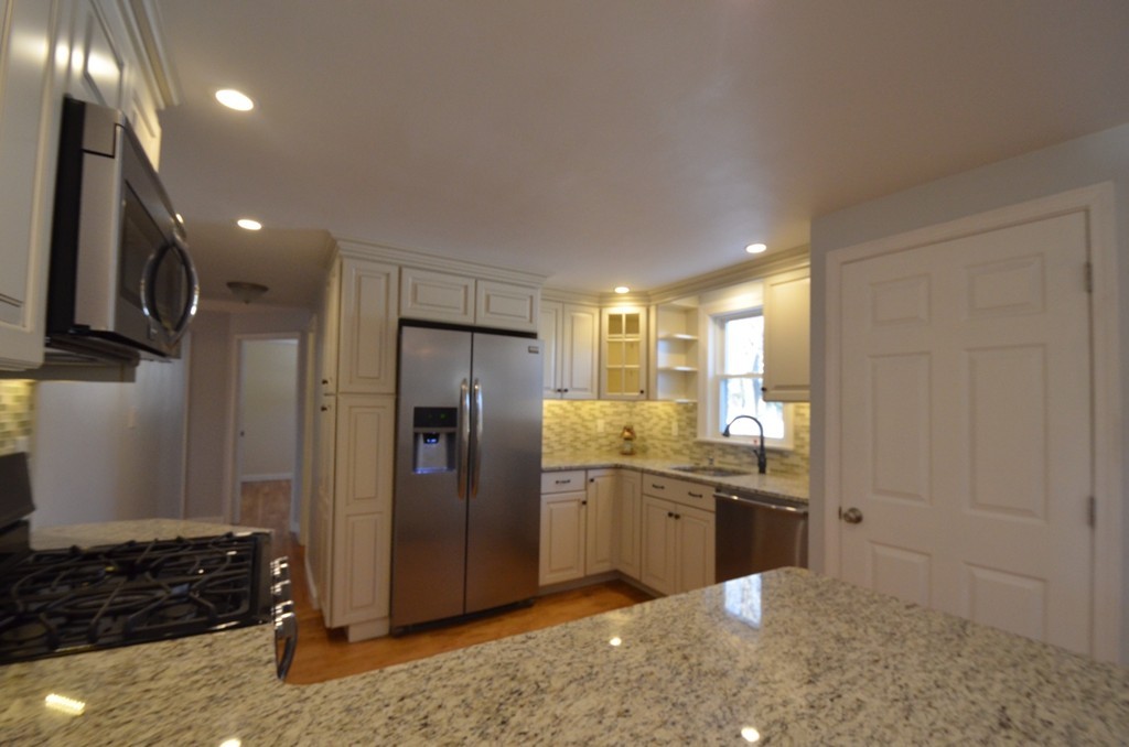1239 Trapelo Road Waltham, MA 02451 - Photo 4 of 20 a kitchen with stainless steel appliances granite countertop a refrigerator and a sink