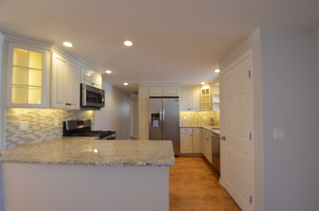 1239 Trapelo Road Waltham, MA 02451 - Photo 5 of 20 a bathroom with a granite countertop sink and a large mirror