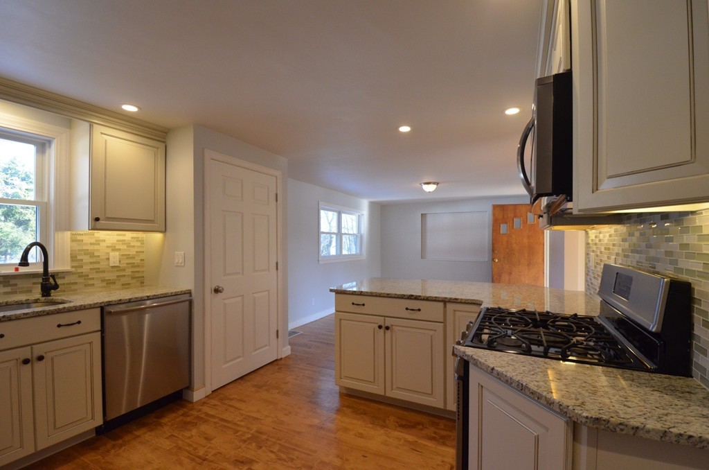 1239 Trapelo Road Waltham, MA 02451 - Photo 6 of 20 a kitchen with stainless steel appliances granite countertop a sink stove and refrigerator