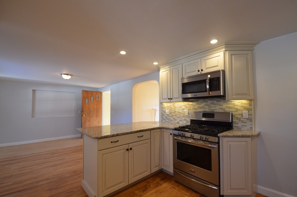 1239 Trapelo Road Waltham, MA 02451 - Photo 7 of 20 a kitchen with stainless steel appliances granite countertop a stove a sink and a microwave