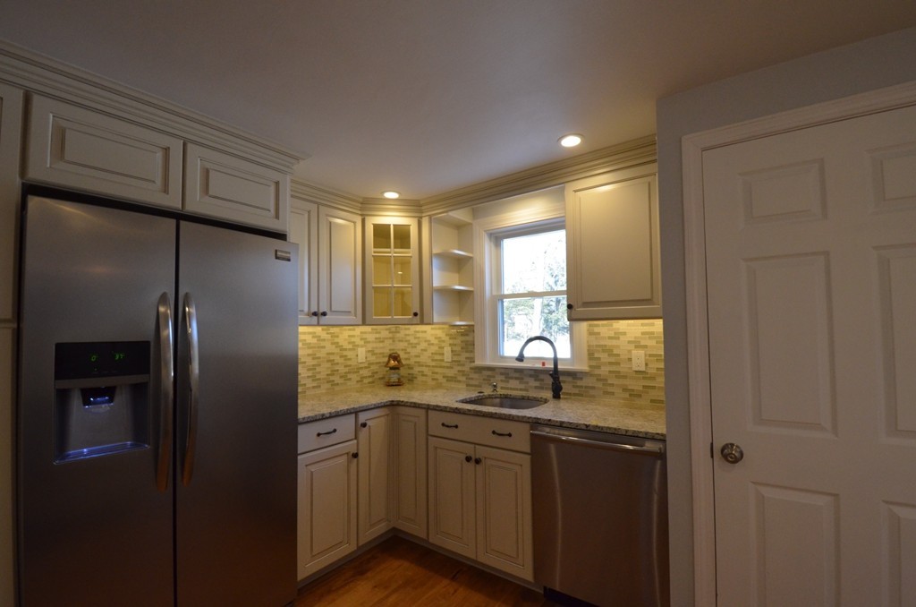 1239 Trapelo Road Waltham, MA 02451 - Photo 8 of 20 a bathroom with a granite countertop sink mirror and refrigerator