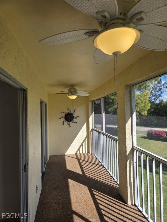 2780 Kings Lake Boulevard, Unit 203 Naples, FL 34112 - Photo 11 of 22 a view of staircase with railing and a chandelier