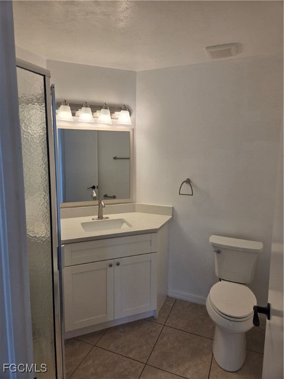 2780 Kings Lake Boulevard, Unit 203 Naples, FL 34112 - Photo 16 of 22 a bathroom with a toilet a sink a mirror and vanity