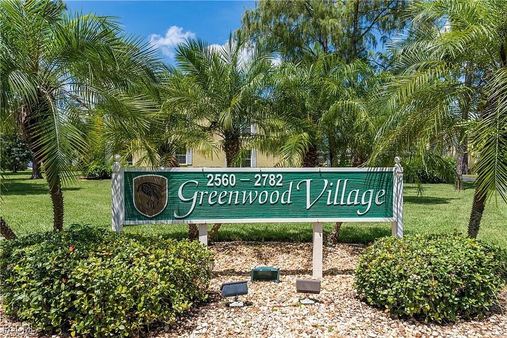 2780 Kings Lake Boulevard, Unit 203 Naples, FL 34112 - Photo 20 of 22 a sign that is sitting in front of a tree