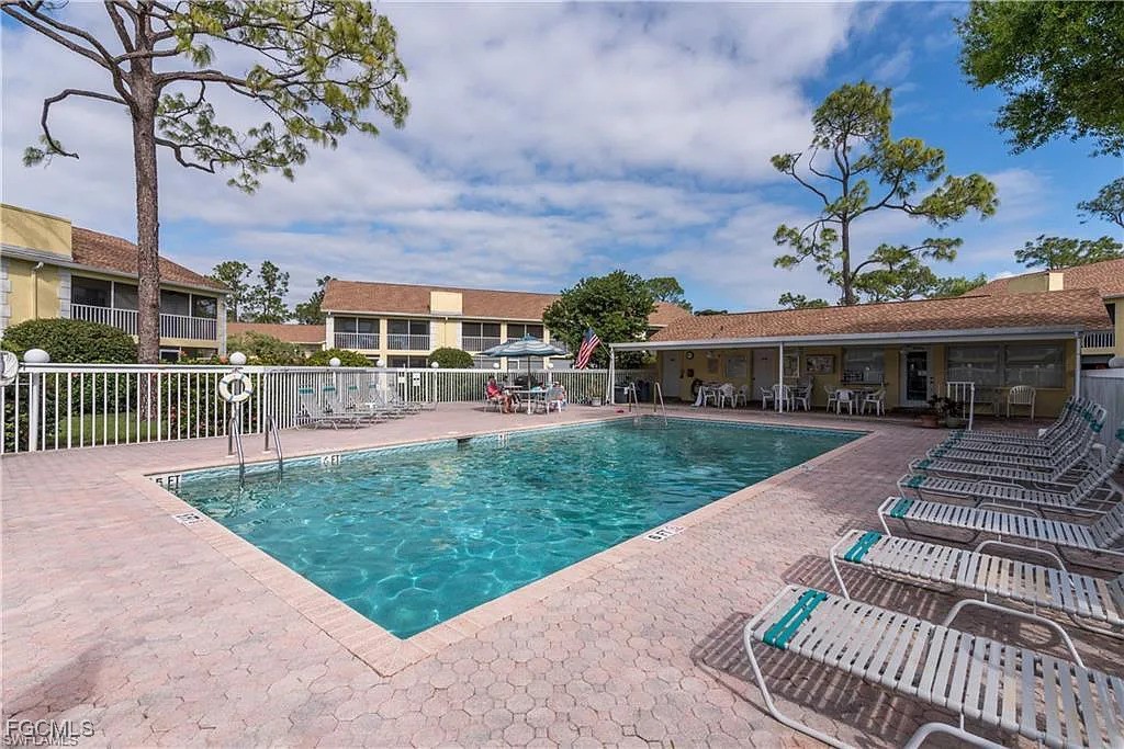 2780 Kings Lake Boulevard, Unit 203 Naples, FL 34112 - Photo 21 of 22 a view of a house with a yard
