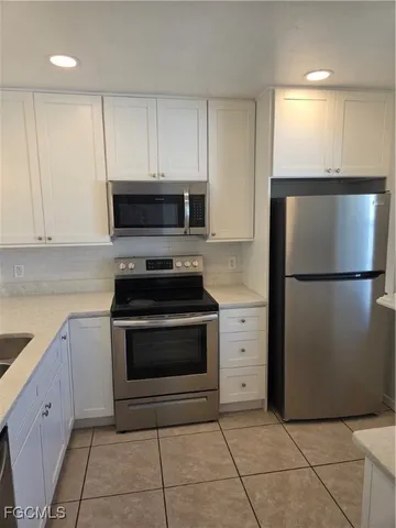 a kitchen with a sink a counter top space and windows