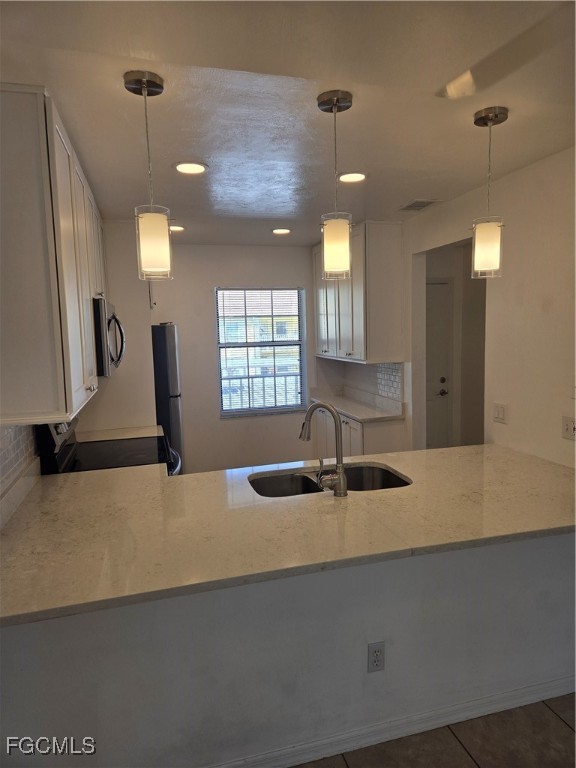 2780 Kings Lake Boulevard, Unit 203 Naples, FL 34112 - Photo 7 of 22 a kitchen with a sink a counter top space and windows