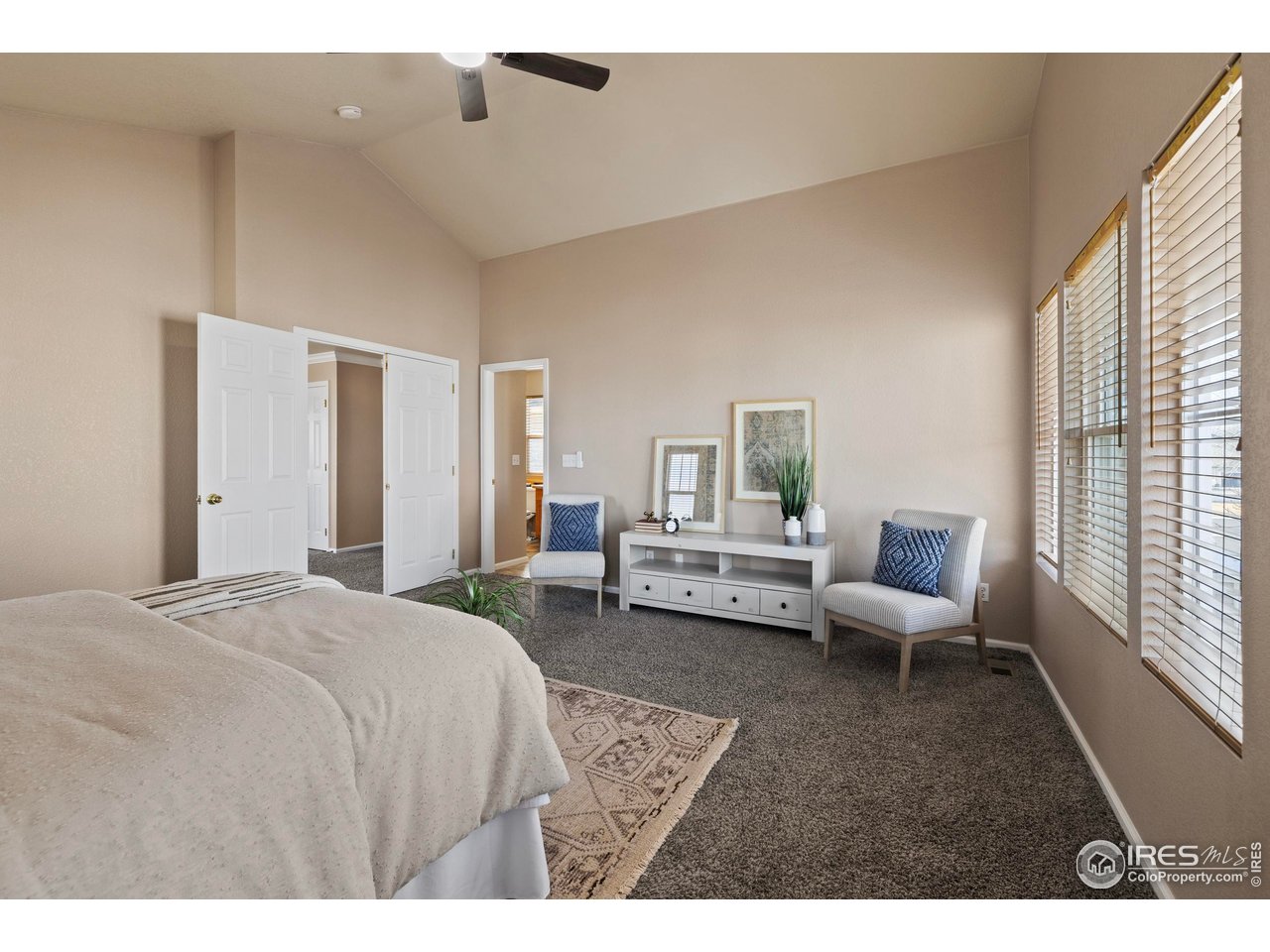 7399 Russell Circle Frederick, CO 80504 - Photo 15 of 35 a spacious bedroom with a bed and wooden floor