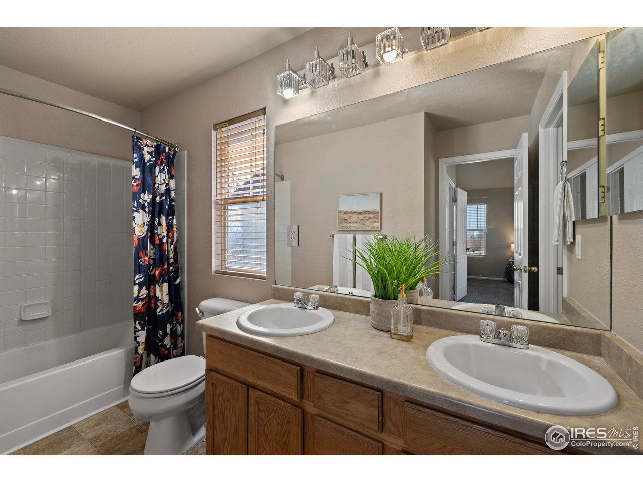 7399 Russell Circle Frederick, CO 80504 - Photo 16 of 35 a bathroom with a double vanity sink toilet mirror and tub